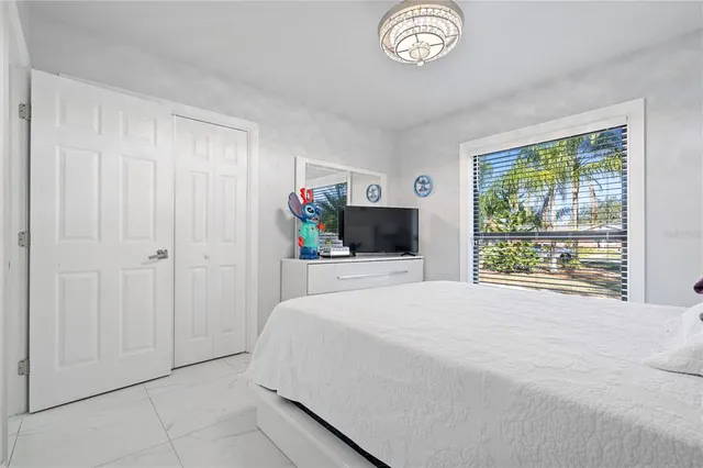 a view of a water fountain in front of a house with large trees