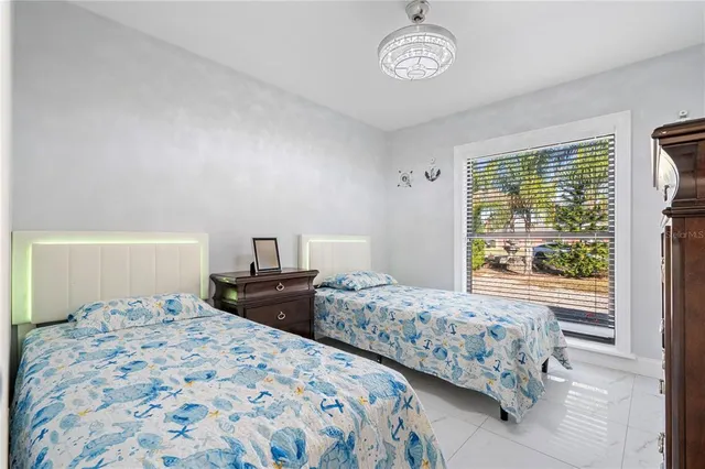 a kitchen with stainless steel appliances kitchen island granite countertop a stove a sink and white cabinets