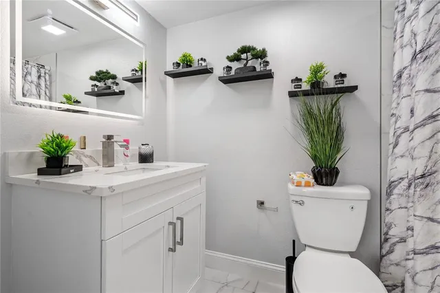 a kitchen with stainless steel appliances a sink and a refrigerator