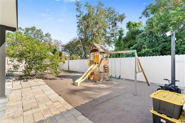 a living room with furniture a flat screen tv and a window