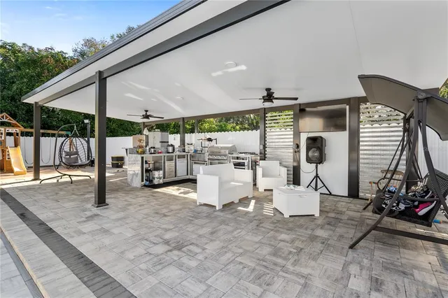 a living room with furniture a clock and a flat screen tv