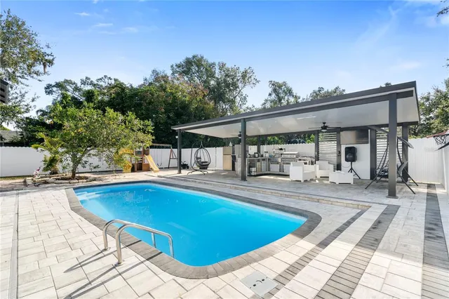 a bathroom with a sink mirror and tub