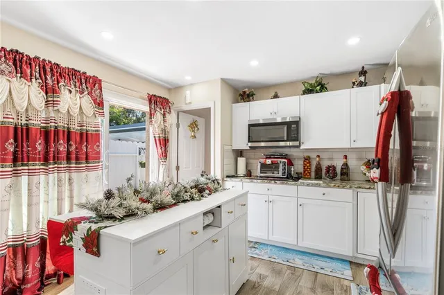 a view of a patio with chairs and potted plants