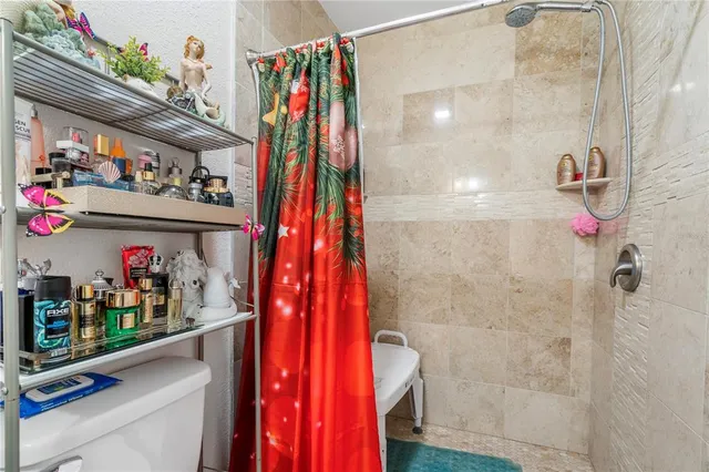 a view of a house with large tree in front of it