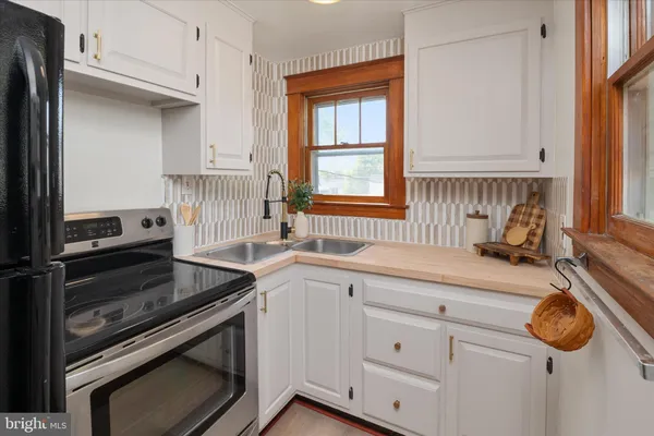 a kitchen with appliances cabinets and a window