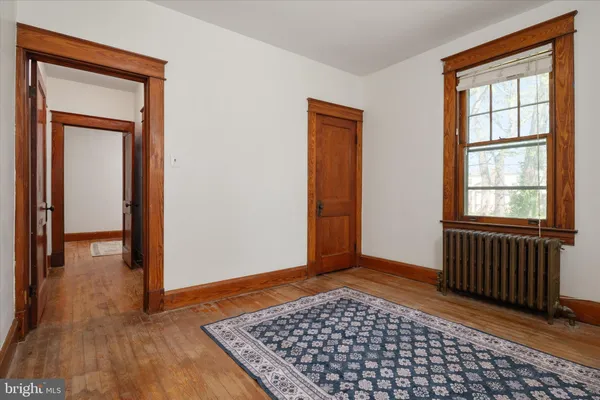 a view of a livingroom with wooden floor and a window
