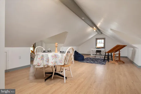 a view of a dining room with furniture and a wooden floor