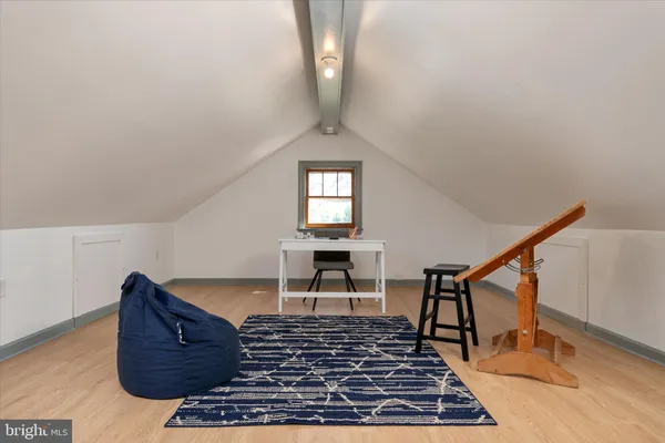 a living room with couch chairs and a rug