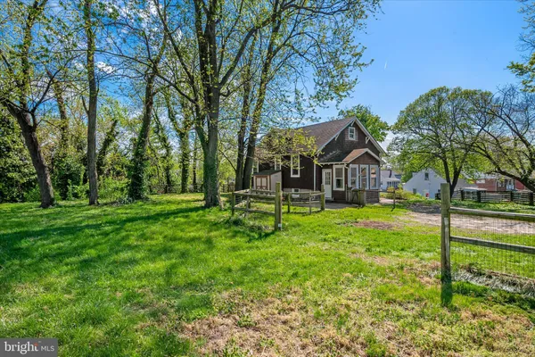 a view of house with backyard and trees