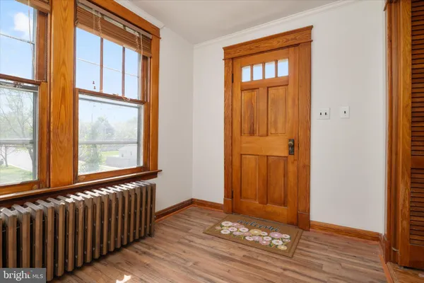 an empty room with wooden floor and a window