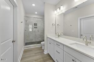 2760 River Meadow Spring Hope, NC 27882 - Photo 24 of 42 a spacious bathroom with a shower sink double and mirror