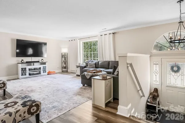 a view of a livingroom with furniture and a flat screen tv