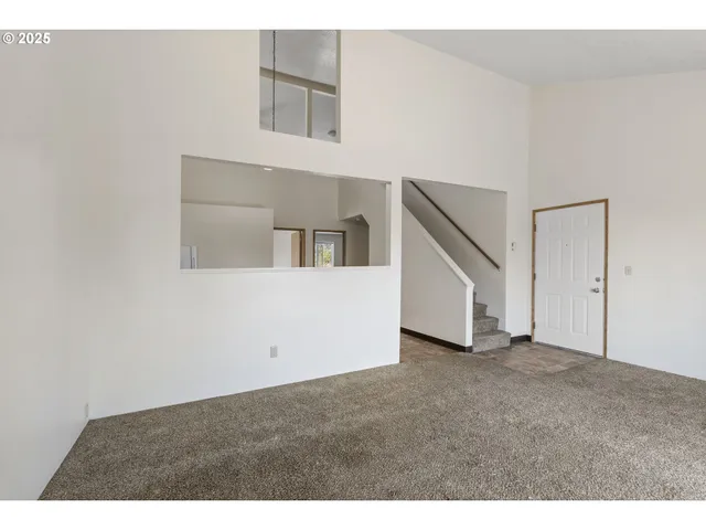 a view of an empty room with stairs