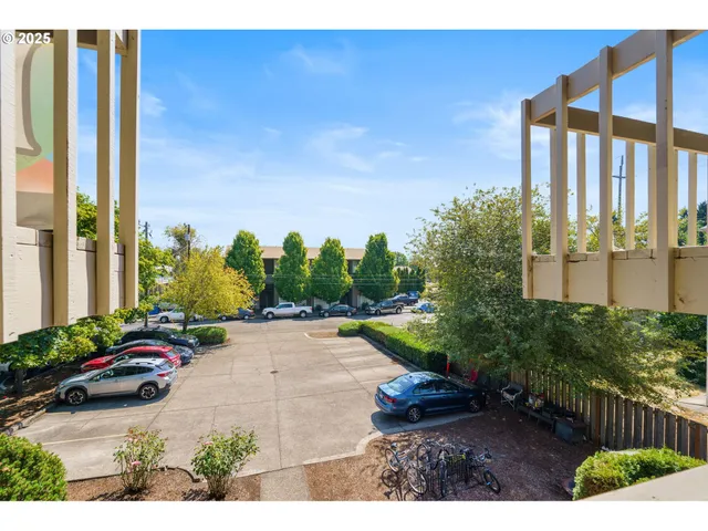 a view of a street with cars parked