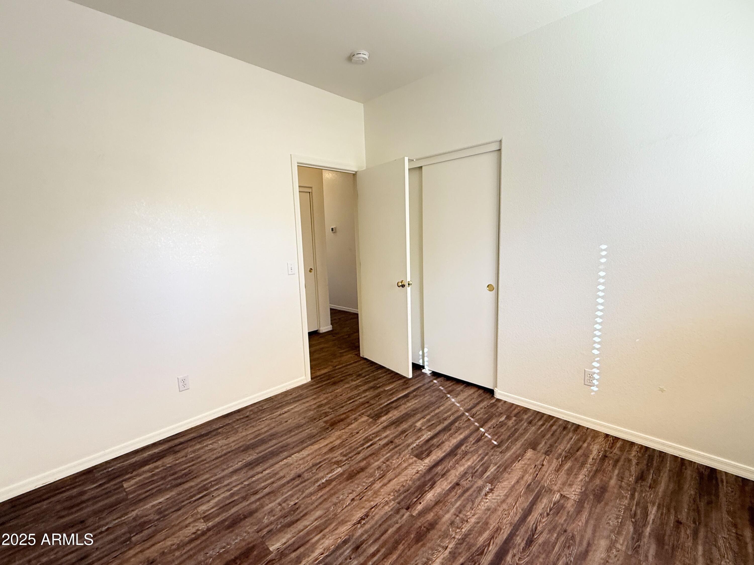 2697 East Waterview Court Chandler, AZ 85249 - Photo 16 of 25 a view of an empty room with wooden floor
