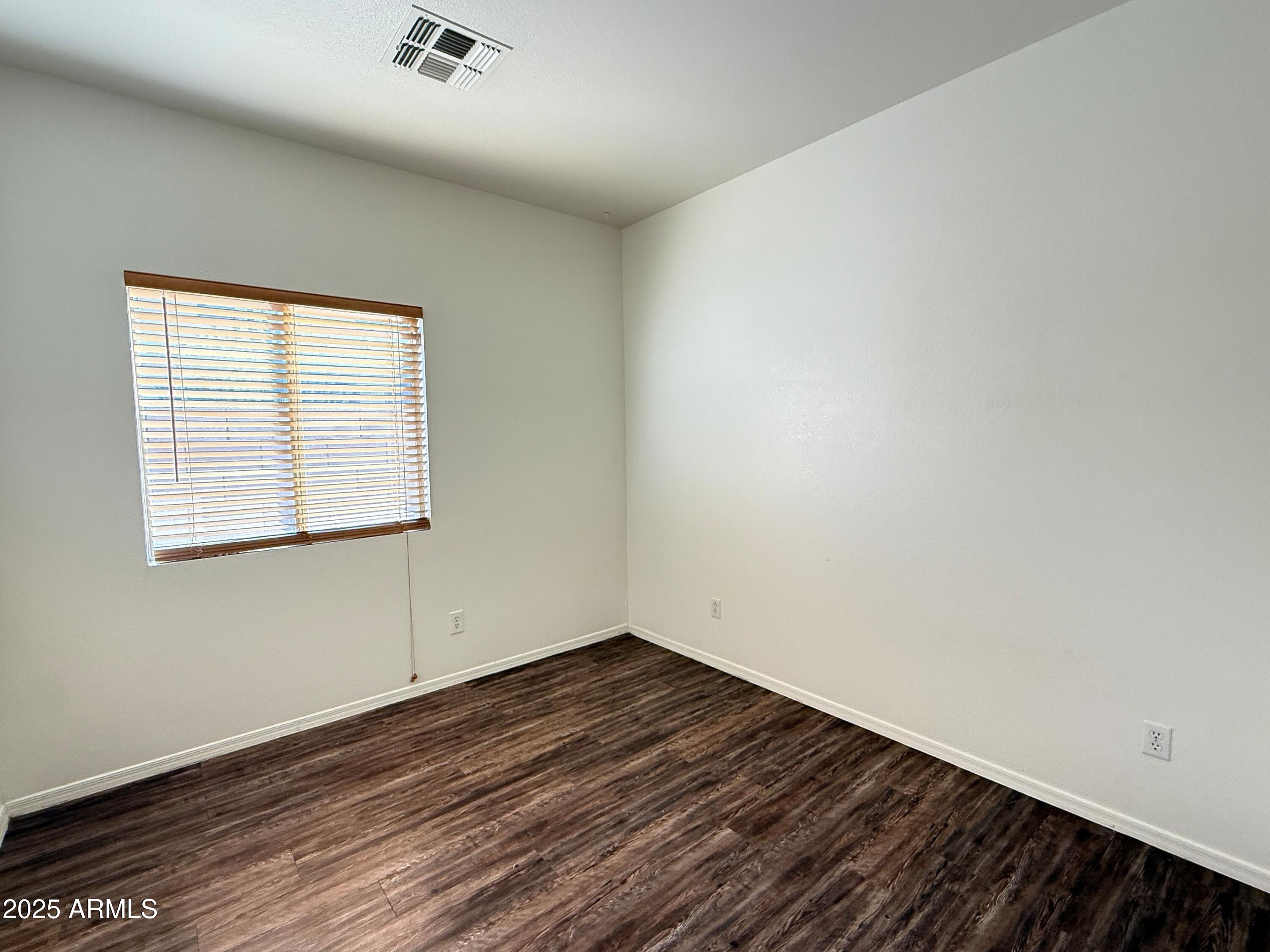 2697 East Waterview Court Chandler, AZ 85249 - Photo 17 of 25 an empty room with wooden floor and windows