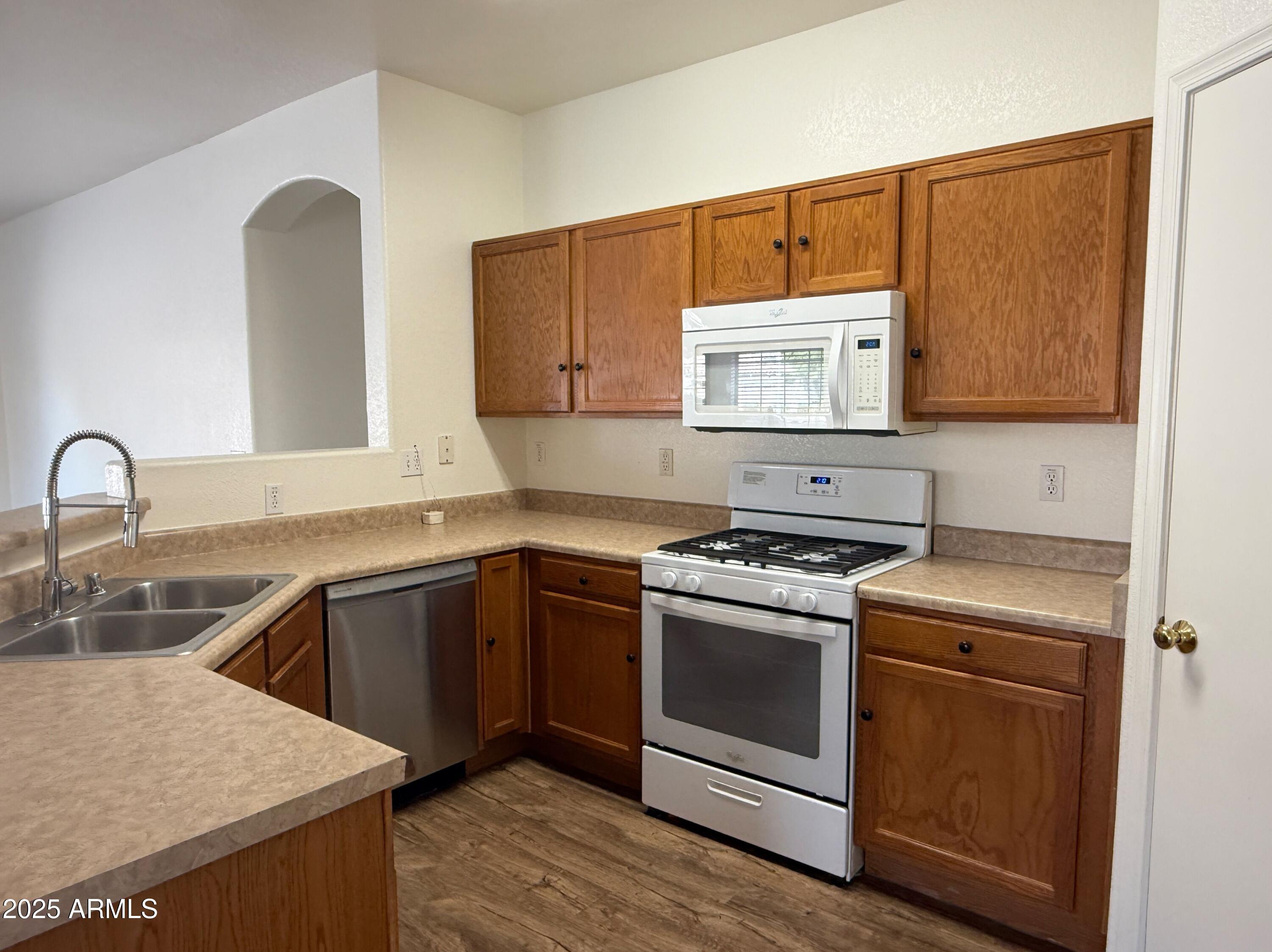 2697 East Waterview Court Chandler, AZ 85249 - Photo 8 of 25 a kitchen with sink a microwave and stove