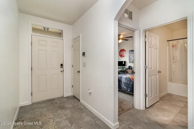 a living room with furniture a flat screen tv and a window