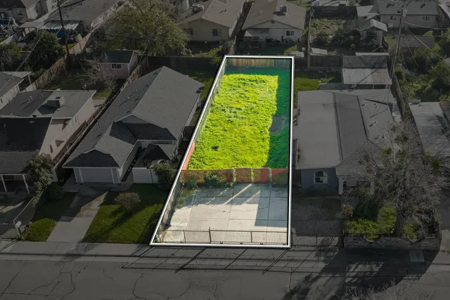 an aerial view of a backyard with swimming pool