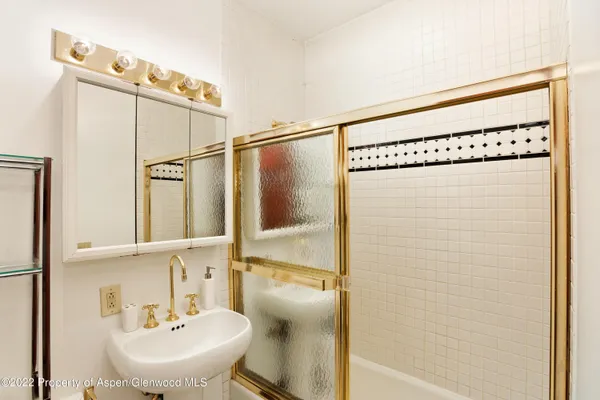 a bathroom with a sink and mirror