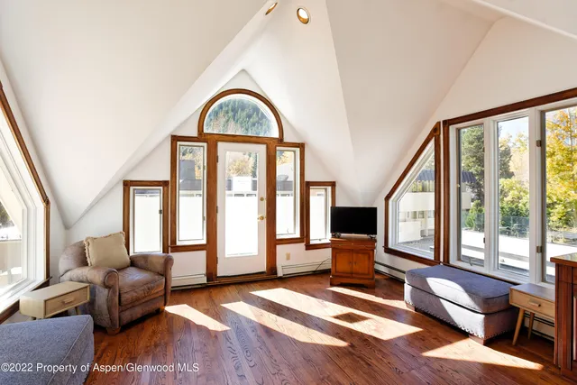 a living room with furniture and a floor to ceiling window