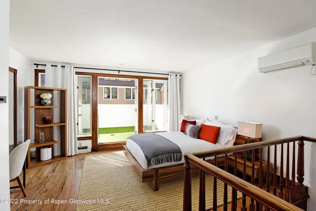 a bedroom with furniture and a window