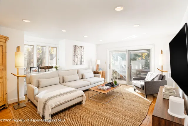 a living room with furniture and a flat screen tv