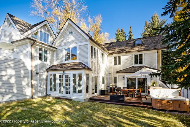 a front view of a house with swimming pool and sitting area