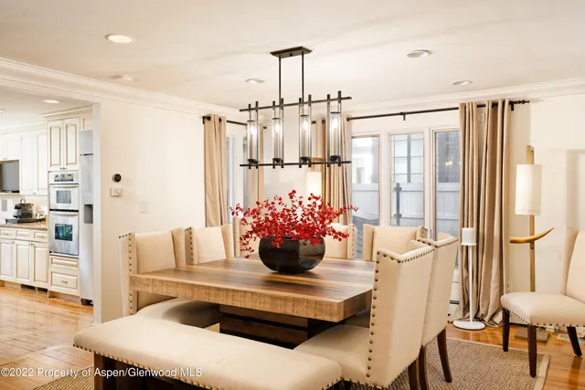 a view of a dining room with furniture and a chandelier