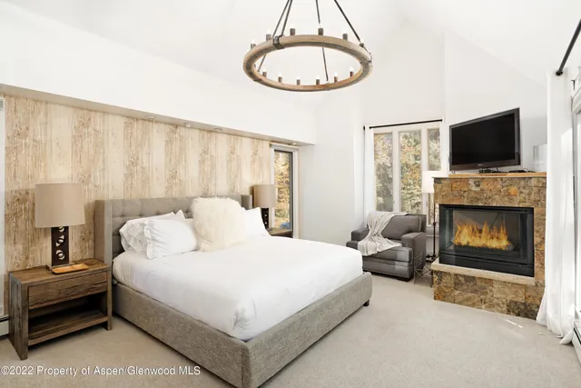 a bedroom with a bed and a fireplace