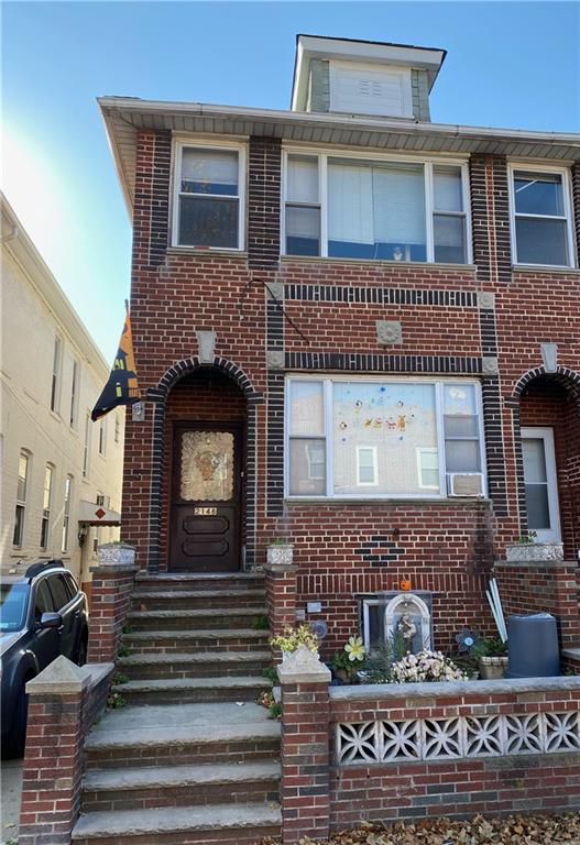 a front view of a house with a garden