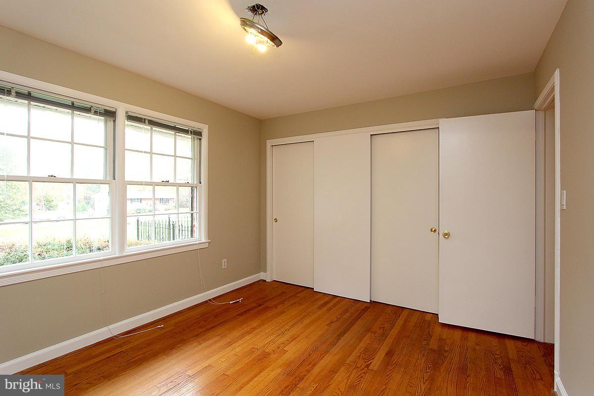 17216 Donora Road Silver Spring, MD 20905 - Photo 17 of 28 a view of an empty room with wooden floor and a window