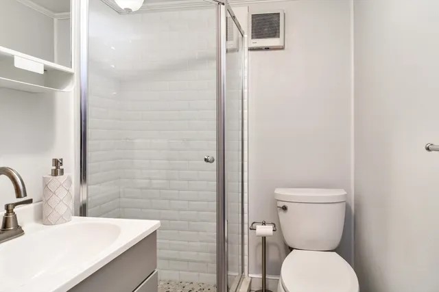 a bathroom with a toilet sink and shower