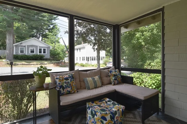 a living room with furniture and a floor to ceiling window