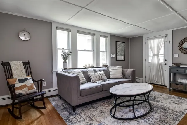 a living room with furniture a fireplace and a table