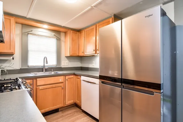 a kitchen with a sink and a refrigerator