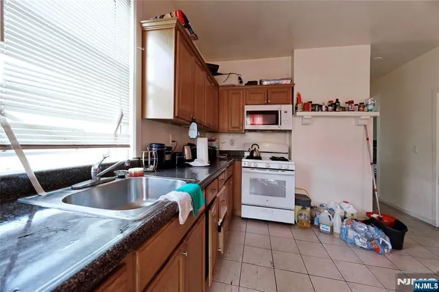 a kitchen that has a sink and cabinets in it