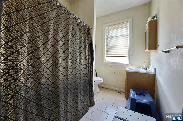 a bathroom with a sink toilet and window