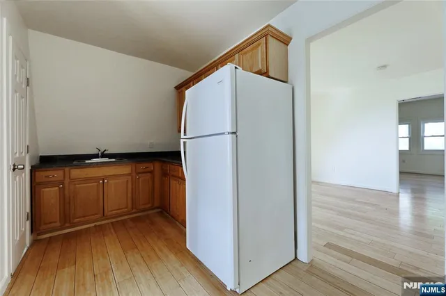 a view of walk in closet with wooden floor