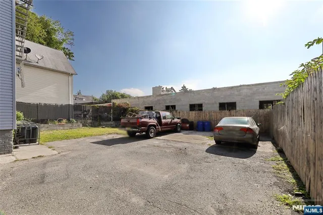 a view of a cars park in front of a house