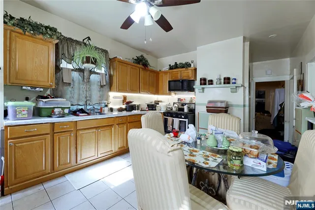 a kitchen with stainless steel appliances kitchen island granite countertop a refrigerator a stove top oven a sink and dishwasher