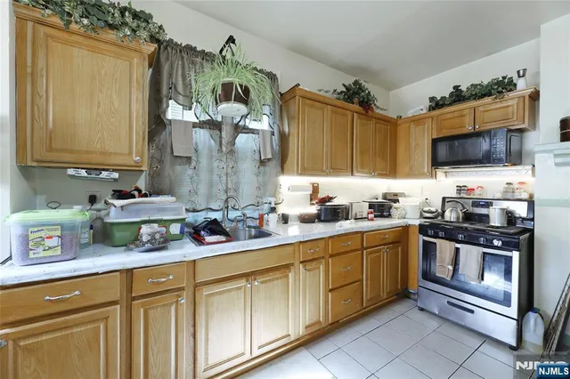 a kitchen with stainless steel appliances granite countertop a sink and a stove