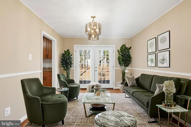 a living room with furniture and a chandelier