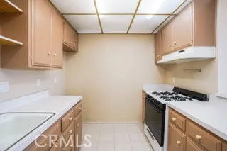 a kitchen with stainless steel appliances granite countertop a sink and a stove