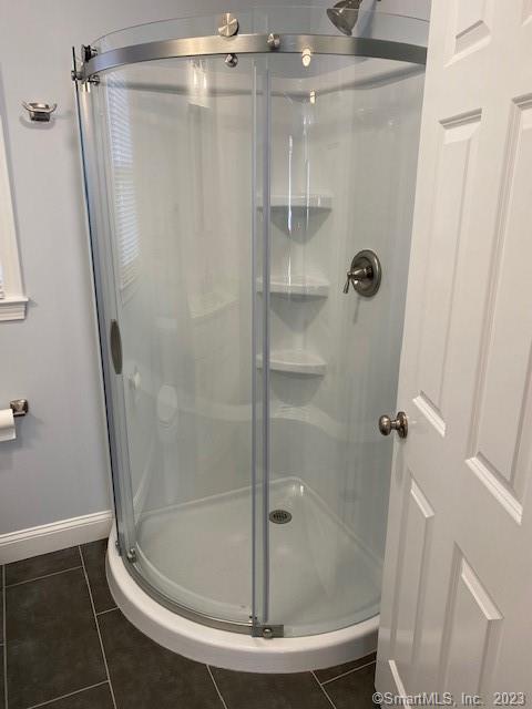 567 Post Road Darien, CT 06820 - Photo 13 of 14 a bathroom with a glass shower door
