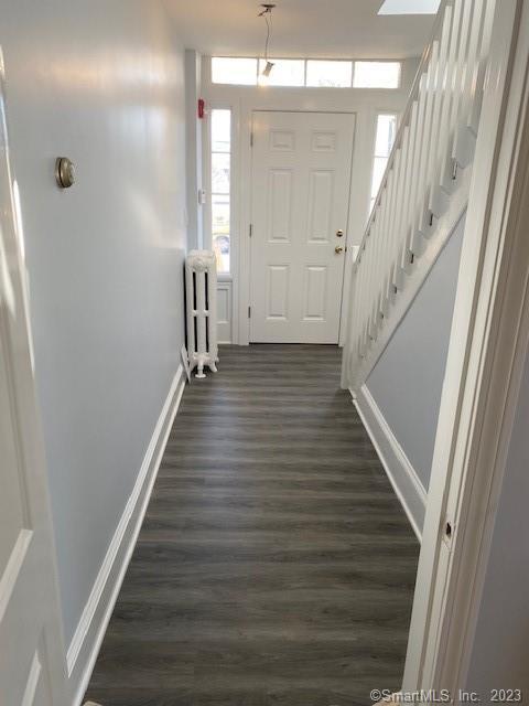 567 Post Road Darien, CT 06820 - Photo 3 of 14 a view of a hallway with wooden floor and staircase