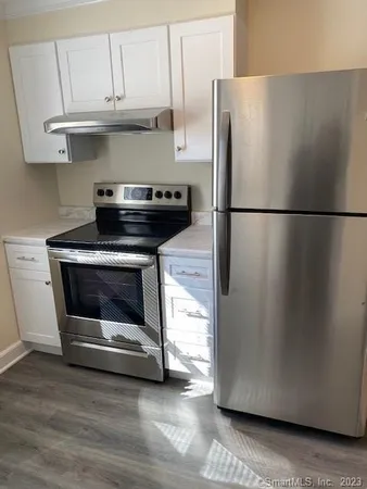 a kitchen with a refrigerator and a stove