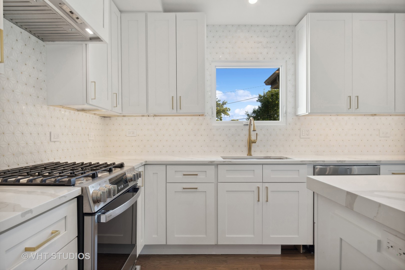 695 Ridge Road Highland Park, IL 60035 - Photo 7 of 23 a kitchen with granite countertop a sink a stove and cabinets