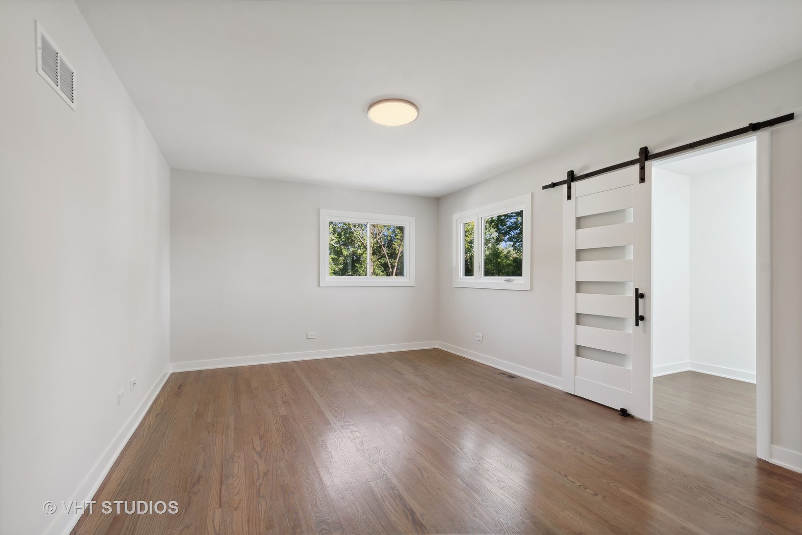 695 Ridge Road Highland Park, IL 60035 - Photo 8 of 23 wooden floor in an empty room with a window