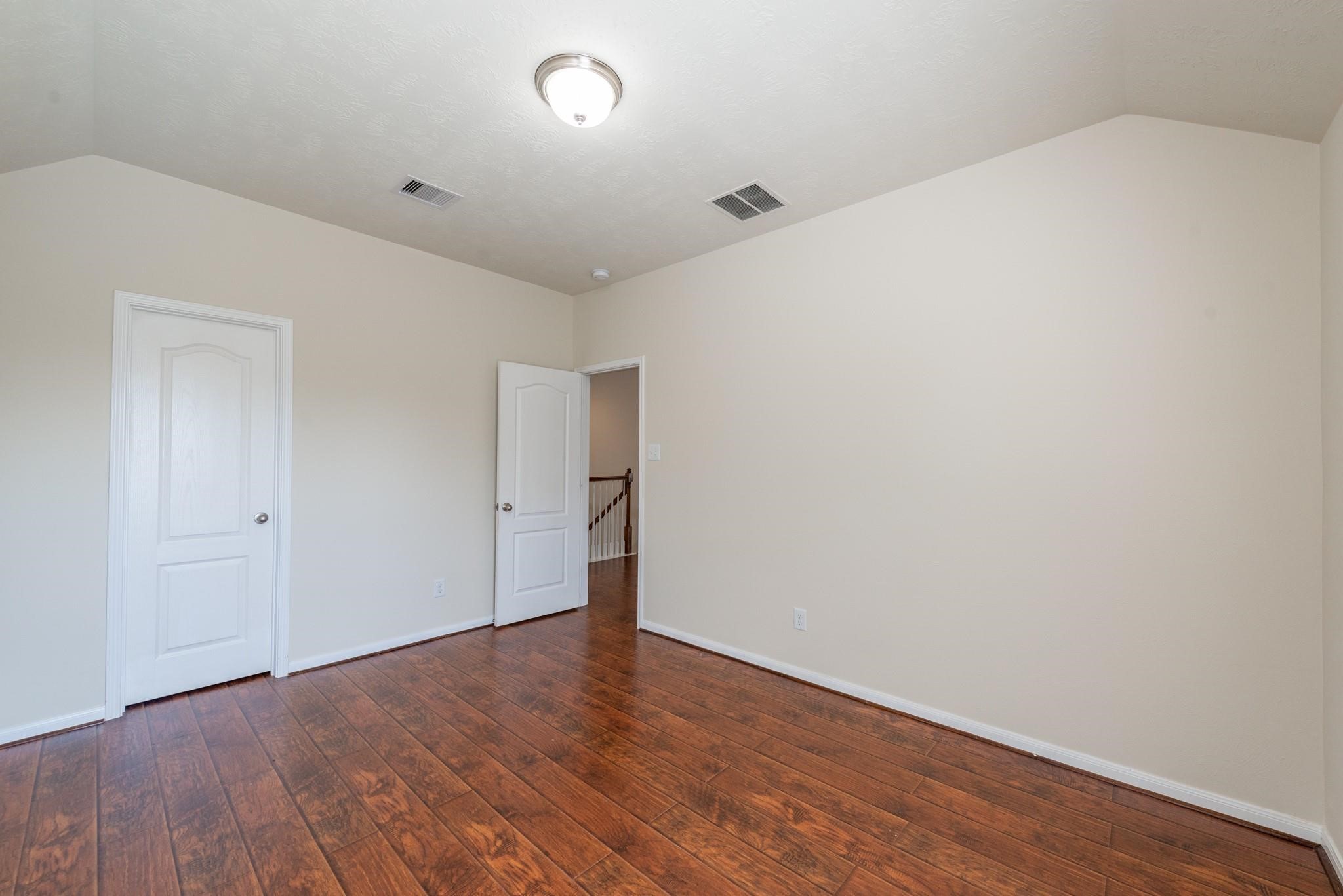 6402 Addlestone Ridge Lane Katy, TX 77494 - Photo 20 of 25 Third bedroom featuring rich wood-look flooring, a large closet, and plenty of room for family, guests, a home office, or study area. Neutral finishes make it easy to personalize and make your own.